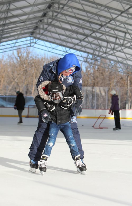 RUTH BONNEVILLE / WINNIPEG FREE PRESS

Story: The True North Youth Foundation  hosts the last of six 2018-19 Welcome to Winnipeg events where they welcome members of the Congo Canada Charity Foundation to experience winter sports at Camp Manitou on Saturday.  

Photo  Camp Manitou worker, Rowan Hurley, helps Bayiek Monybuny (8yrs), to skate on the outdoor rink at Camp Manitou on Saturday.  

 
January 26th,  2019
