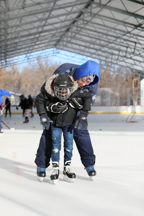 RUTH BONNEVILLE / WINNIPEG FREE PRESS

Story: The True North Youth Foundation  hosts the last of six 2018-19 Welcome to Winnipeg events where they welcome members of the Congo Canada Charity Foundation to experience winter sports at Camp Manitou on Saturday.  

Photo  Camp Manitou worker, Rowan Hurley, helps Bayiek Monybuny (8yrs), to skate on the outdoor rink at Camp Manitou on Saturday.  

 
January 26th,  2019
