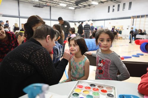 RUTH BONNEVILLE / WINNIPEG FREE PRESS

Story: The Newcomer Community Hub,  located inside Ryerson School, hosts its grand opening Saturday. 

Photo of kids getting their face painted  at grand opening for the Hub  Saturday.  

Pembina Trails School Division has recently welcomed an increasing number of refugees into its schools. In order to support the community, with a current focus on Yazidi refugees, a unique relationship has been created with Immigration Partnership Winnipeg, the Manitoba Association of Newcomer Serving Organizations and a number of other groups called, The Newcomer Community Hub.   It is located in Ryerson School in Pembina Trails School Division and is a one-stop shop of services that traditionally have been located in the citys downtown.   The Newcomer Community Hub held its formal grand opening with food, activities for kids and ribbon cutting ceremony.  

See Solomon's story. 
 
January 26th,  2019
