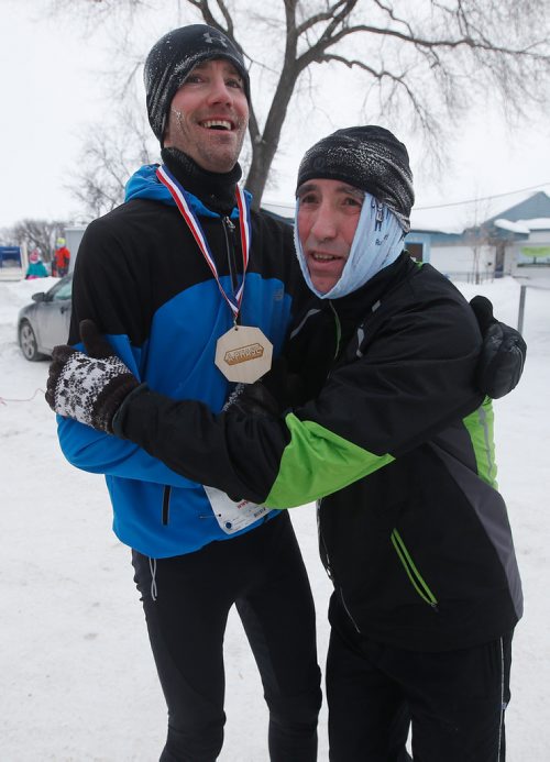 JOHN WOODS / WINNIPEG FREE PRESS
Jason Bruce, left. the winner of the 5km section, and second place runner Aldo Furland embrace after finishing the 6th annual Frostbite River Run, a fundraiser in support of programming and activities at Riverview Community Centre in WinnipegSunday, January 27, 2019. The Frostbite River Run is part of the Riverview Winter Classic - a series of outdoor events held in January at the community centre.