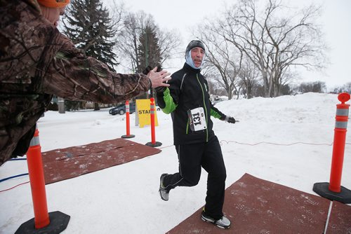 JOHN WOODS / WINNIPEG FREE PRESS
Aldo Furland get a high five as he finishes the 5km section of the 6th annual Frostbite River Run, a fundraiser in support of programming and activities at Riverview Community Centre in WinnipegSunday, January 27, 2019. The Frostbite River Run is part of the Riverview Winter Classic - a series of outdoor events held in January at the community centre.