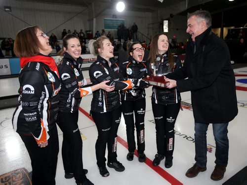 TREVOR HAGAN / WINNIPEG FREE PRESS
Coach, Andrea Ronnebeck, second, Liz Fyfe, lead, Kristin MacCuish, third, Selena Njegovan, and skip,Tracy Fleury laughing with Rynie Nachtigal of Kruger Products as he presents them the trophy after defeating Team Kerri Einarson during the Scotties final in Gimli, Sunday, January 27, 2019.