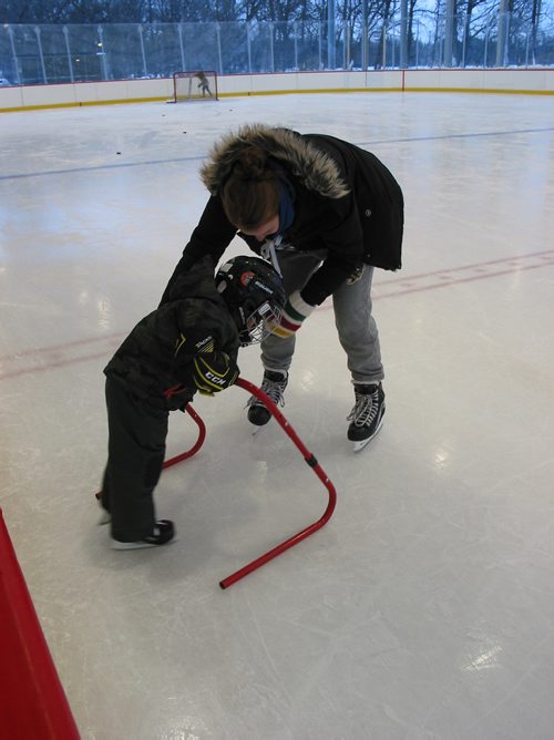 Canstar Community News Jan. 13, 2019 - A Camp Manitou staff member helps a youngster take his first few steps on the hockey rink on Jan. 13 as part of a Welcome Place event meant to help newcomer families try out typical Manitoba winter activities. (ANDREA GEARY/CANSTAR COMMUNITY NEWS)