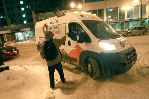 PHIL HOSSACK / WINNIPEG FREE PRESS - Emmanuel Olatubosun hands out a fist pump along with a hot cup of coffee to a man living on the streets Thursday night. January 31, 2019
