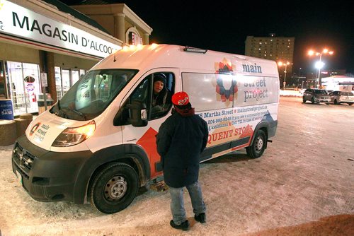 PHIL HOSSACK / WINNIPEG FREE PRESS - Robin EastMan reaches out to a man living on the streets Thursday night. January 31, 2019