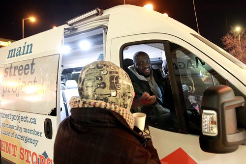 PHIL HOSSACK / WINNIPEG FREE PRESS - Emmanuael Olatubosun chats over a hot coffee to a woman living on the streets Thursday night. January 31, 2019