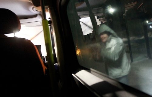 PHIL HOSSACK / WINNIPEG FREE PRESS - Cold and hungry a homeless man leaves a city transit shelter to receive a coffee a sandwich and a pair of gloves from the Main Street Project's Outreach van Thursday night. January 31, 2019