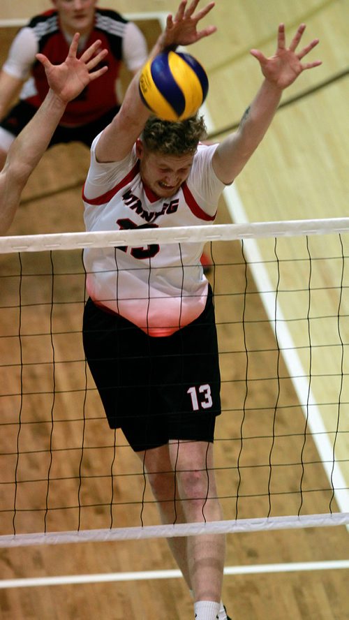 PHIL HOSSACK / WINNIPEG FREE PRESS -  Winnipeg Wesmen's #13 Ethan Duncan blocks against the Manitoba Bisons Friday night at the Investor's Group Athletic Centre.  February 1, 2019