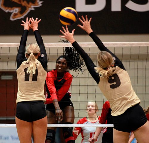 PHIL HOSSACK / WINNIPEG FREE PRESS - Wesmen Women #10 Kelysian Warmington fires through Manitoba Bison defenders #11 Tori Studler and #9 Joselyn Coswin at the Wesmen Classic Volleyball tournament Friday. -February 1, 2019