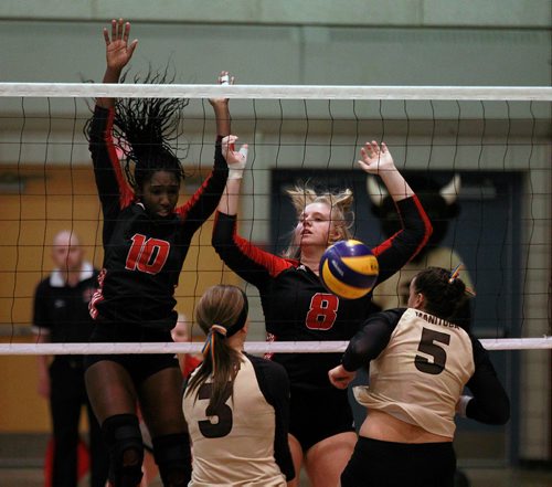 PHIL HOSSACK / WINNIPEG FREE PRESS - Wesmen Women #10 Kelysian Warmington and #8 Ashleigh Laube block a Manitoba Bison attempt from #3 Laura Findley and #5 Kearley Abbot at the Wesmen Classic Volleyball tournament Friday. -February 1, 2019