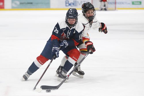 JOHN WOODS / WINNIPEG FREE PRESS
St Mary's Academy's Kane Gregoire (16) works to get around Lloydminster PMW Steelers' Brooklyn Palmer (27) in first period of the gold medal game at the Female World Sport School Challenge at Iceplex in Winnipeg Sunday, February 3, 2019.