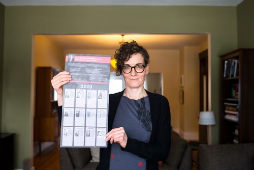 MIKAELA MACKENZIE / WINNIPEG FREE PRESS
English professor Heather Milne poses with the all-male "notable Canadians" calendar that liberal MP Robert-Falcon Ouellette sent out in Winnipeg on Wednesday, Feb. 6, 2019. 
Winnipeg Free Press 2019.