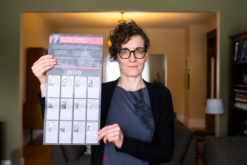 MIKAELA MACKENZIE / WINNIPEG FREE PRESS
English professor Heather Milne poses with the all-male "notable Canadians" calendar that liberal MP Robert-Falcon Ouellette sent out in Winnipeg on Wednesday, Feb. 6, 2019. 
Winnipeg Free Press 2019.