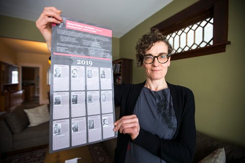 MIKAELA MACKENZIE / WINNIPEG FREE PRESS
English professor Heather Milne poses with the all-male "notable Canadians" calendar that liberal MP Robert-Falcon Ouellette sent out in Winnipeg on Wednesday, Feb. 6, 2019. 
Winnipeg Free Press 2019.