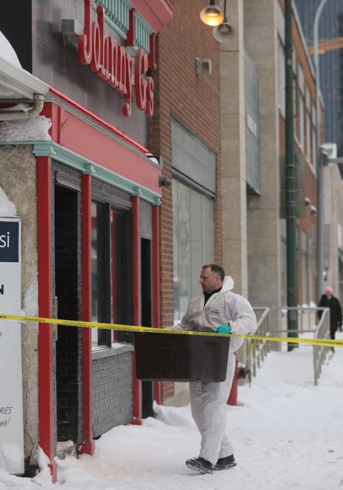 TREVOR HAGAN/ WINNIPEG PRESS
A member of the WPS's forensic investigation unit at the scene of a double homicide at Johnny G's on Main Street, Wednesday, February 6, 2019.