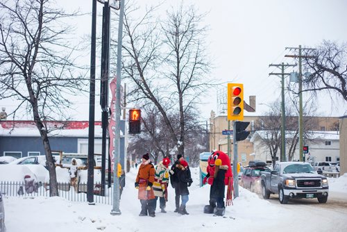 MIKAELA MACKENZIE / WINNIPEG FREE PRESS
Léo La Tuque and other Festival du Voyageur people wait to cross Provencher Boulevard before recognizing the Festival du Voyageurs 50th anniversary with an honourary street naming of St. Joseph St. in Winnipeg on Thursday, Feb. 7, 2019. 
Winnipeg Free Press 2019.