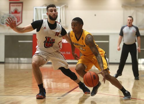 TREVOR HAGAN / WINNIPEG FREE PRESS
Winnipeg Wesmen Adam Benrabah and Manitoba Bisons' guard Rashawn Browne (4) during a single game elimination, Wednesday, February 6, 2019.