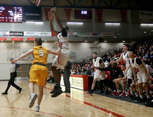 TREVOR HAGAN / WINNIPEG FREE PRESS 
The Winnipeg Wesmen bench reacts as Narcisse Ambanza (3) drains a 3 pointer in front of Manitoba Bisons' guard Zach Giesbrecht (5) during a single game elimination, Wednesday, February 6, 2019.