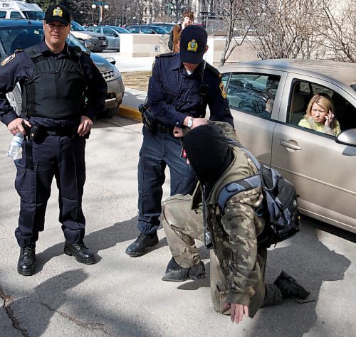 BORIS MINKEVICH / WINNIPEG FREE PRESS  090420 4:20 at the Leg. Police help an impared person who was caught crawling down the road.