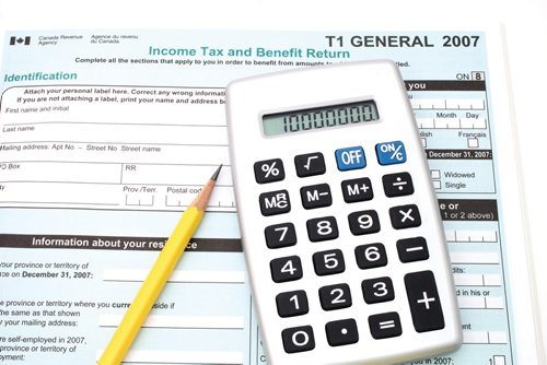 Canstar Community News calculator and pencil over a  canadian general tax return form