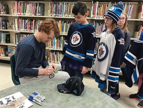 Canstar Community News Mason Appleton of the Winnipeg Jets signed autographs for students at Bird's Hill School following a reading for I Love to Read Month. (SHELDON BIRNIE/CANSTAR/THE HERALD)