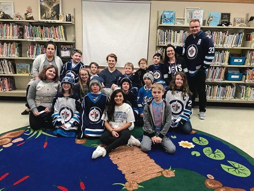 Canstar Community News Mason Appleton of the Winnipeg Jets read to a Grade 4/5 class at Bird's Hill School on Feb. 4 for I Love to Read Month. (SHELDON BIRNIE/CANSTAR/THE HERALD)