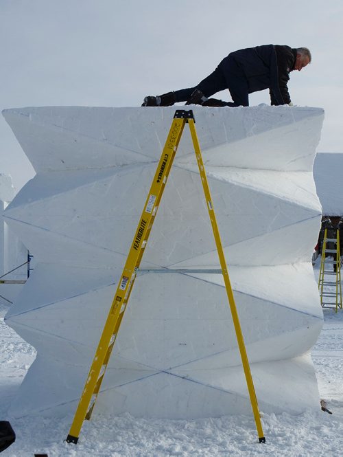 MIKE DEAL / WINNIPEG FREE PRESS
Jacques Boulet from Winnipeg helps clean off the top of Franziska Agrawals sculpture Prisma which is part of the International Snow Sculpture Symposium at the Festival du Voyageur which kicks off today.
190214 - Thursday, February 14, 2019.