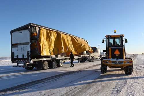 MIKE DEAL / WINNIPEG FREE PRESS
Crews work to clean up after a CN train collided with a semi-trailer when it got stuck trying to turn off Wilkes north onto PR 334 around 3 a.m. Friday. No injuries were reported and the train did not derail. 
190215 - Friday, February 15, 2019