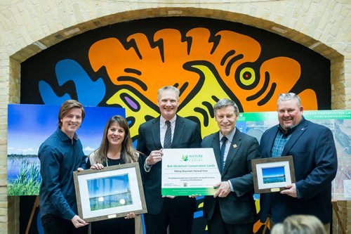 MIKAELA MACKENZIE / WINNIPEG FREE PRESS
Josh Mickelson (left), Therese Mickelson, Jim Mickelson, Terry Duguid, and Kevin Teneycke pose for a group photo after announcing a land donation near Riding Mountain National Park, which will protect grasslands, lakes and wetlands, at the Forks in Winnipeg on Monday, Feb. 18, 2019.
Winnipeg Free Press 2019.