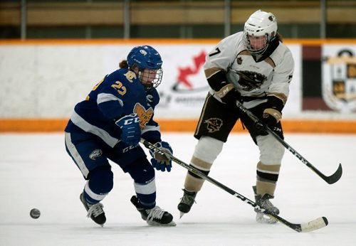 PHIL HOSSACK / WINNIPEG FREE PRESS - Manitoba Bison #7 Erin Kucheravy keeps the puck away from UBC Thunderbird #22 Hannah Clayton-Caroll in playoff action Friday night.  - February 22, 2019.