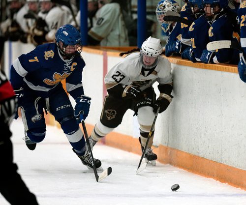 PHIL HOSSACK / WINNIPEG FREE PRESS - Manitoba Bison #23 Lauryn Keen and UBC Thunderbird #7 Celine Tardif chase the puck in playoff action Friday night.  - February 22, 2019.