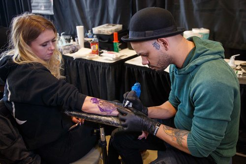 MIKE DEAL / WINNIPEG FREE PRESS
Sydney Breckman-Antony gets a tattoo by Babiery Hernandez an award winning tattoo artist based in Westchester, NY, who was a contestant on the TV Show, Ink Master.
Hundreds mingle and browse while others get tattooed by some of the best artists during the Winnipeg Tattoo Show at the RBC Convention centre Saturday afternoon.
190223 - Saturday, February 23, 2019.