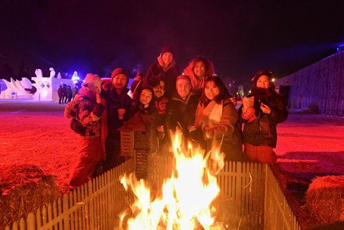 Mike Sudoma / Winnipeg Free Press
(Left to right) Amiyah, nounith, Isis, Daniel, Josie. Matt, Jamie. Elyssa, Ava warm up in front of a campfire during Festival Du Voyageur Friday evening 
February 22, 2018
