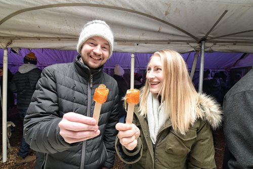 Mike Sudoma / Winnipeg Free Press
Blair Einarson and Joelle Boileau Enjoy a sugar stick inside the sugar shack at Festival Du Voyageur Friday evening
February 22, 2018
