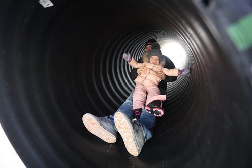TREVOR HAGAN/ WINNIPEG PRESS
Matt Keough holding Esmée, 2, on a tube slide during the last day of Festival du Voyageur, Sunday, February 24, 2019.