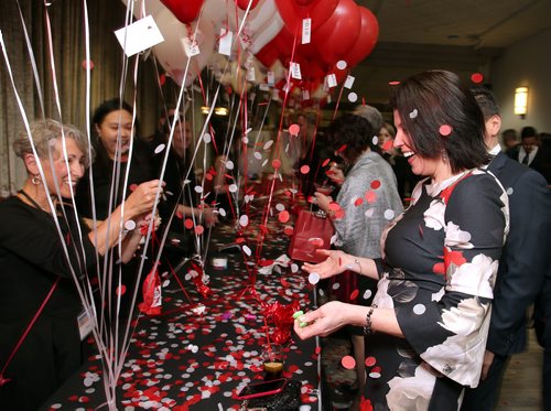 JASON HALSTEAD / WINNIPEG FREE PRESS

Celina Flett pops a confetti-filled balloon to receive her gift bag at the Alzheimer Society of Manitoba's A Night in Croatia Gala on Feb. 7 2019 at the RBC Convention Centre Winnipeg. (See Social Page)