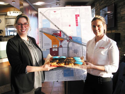 Canstar Community News Feb. 20, 2019 - (From left) CentrePort Canada's executive director of marketing and communications, Carly Emundson and co-owner of the Tim's location at 11 Davis Way in Rosser, Jamie Pope show off the three specially designed doughnuts that represent the truck, rail and air connections within CentrePort Canada. The doughnuts were distributed at an informational event held on Feb. 20. (ANDREA GEARY/CANSTAR COMMUNITY NEWS)
