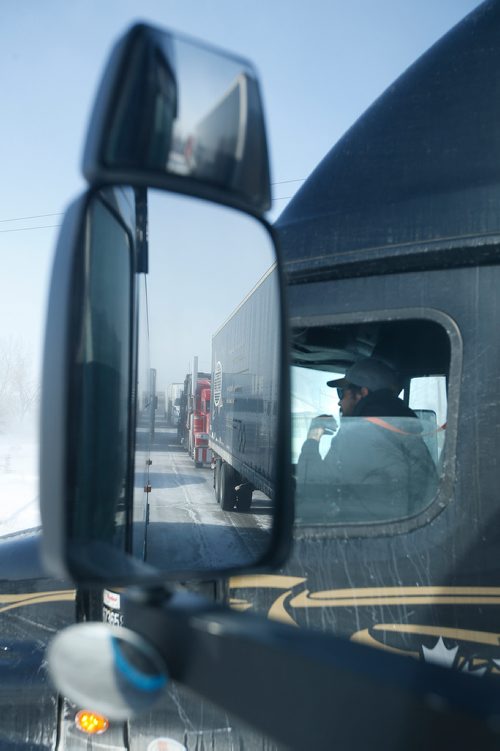 JOHN WOODS / WINNIPEG FREE PRESS
Roger Hamelin, a bus driver with Beaver Bus Lines, and truck drivers wait for 3.5 hours in Headingley for the road to open so he can drive his bus  to Waywayseecappo and back Sunday, February 24, 2019. Hamelin drove from Winnipeg to Steinbach to pick up the Steinbach Pistons and then onto Waywayseecappo where they played the Waywayseecappo Wolverines and then back to Winnipeg in what turned out to be an eighteen hour day.