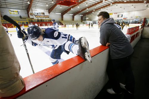 JOHN WOODS / WINNIPEG FREE PRESS
Steinbach Pistons Ryan Dyck, equipment manager, looks on as Troy Beauchemin stretches during warmup in Waywayseecappo arena  prior to their game Sunday, February 24, 2019. Steinbach Pistons hit the road on a bus to Waywayseecappo where they played the Waywayseecappo Wolverines and then returned to Steinbach for a 17.5 hour day.
