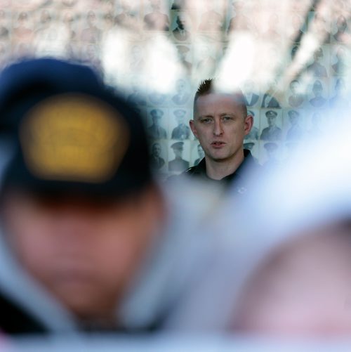 PHIL HOSSACK / WINNIPEG FREE PRESS - From inside, a city police officer monitors about a hundred members of the Sudanese community and others rallied in front of Police HQ Friday afternoon to protest the Police shooting death of Machuar Madut in February. See Alex Paul story. - March 1, 2019.