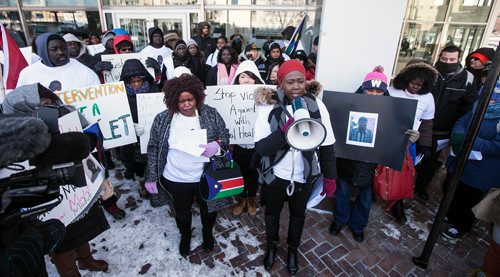 PHIL HOSSACK / WINNIPEG FREE PRESS -Holding the megaphone, Sandy Deng hosts about a hundred members of the Sudanese community and others rallied in front of Police HQ Friday afternoon to protest the Police shooting death of Machuar Madut in February. See Alex Paul story. - March 1, 2019. 

**Alex will get the names of the two women in front.**