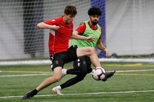 Forward Tyler Attardo (left) fends off Federico Pena during Valour FC's first team practice Monday, March 5, 2019.
 (John Woods / Winnipeg Free Press)