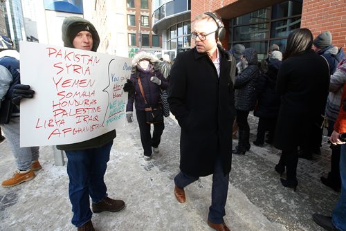 JOHN WOODS / WINNIPEG FREE PRESS
Tom (did not want last name used), left, hands out brochures as he protests the Barrack Obama speech outside a downtown arena Monday, March 4, 2019.