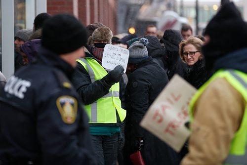 JOHN WOODS / WINNIPEG FREE PRESS
A person, who identified as being connected to Yellow Vests Canada, holds a sign as people line up to attend the Barrack Obama speech at a downtown arena Monday, March 4, 2019.