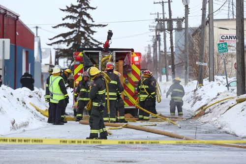 MIKE DEAL / WINNIPEG FREE PRESS
Winnipeg Firefighters clean up after battling a house fire in the 900 block of Alexander Ave Tuesday morning. 
190305 - Tuesday, March 5, 2019
