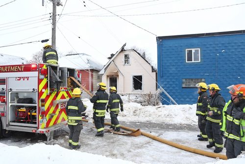 MIKE DEAL / WINNIPEG FREE PRESS
Winnipeg Firefighters clean up after battling a house fire in the 900 block of Alexander Ave Tuesday morning. 
190305 - Tuesday, March 5, 2019