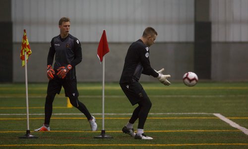 MIKE DEAL / WINNIPEG FREE PRESS
FC Valour goaltender Tyson Farago catches the ball while Mathias Janssens watches during practice at the Subway South Soccer Complex Tuesday morning.
190305 - Tuesday, March 05, 2019.
