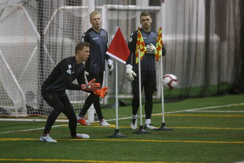 MIKE DEAL / WINNIPEG FREE PRESS
FC Valour goaltender Mathias Janssens catches the ball while Svyatik Artemenko (centre) and Tyson Farago (right) watch during practice at the Subway South Soccer Complex Tuesday morning.
190305 - Tuesday, March 05, 2019.