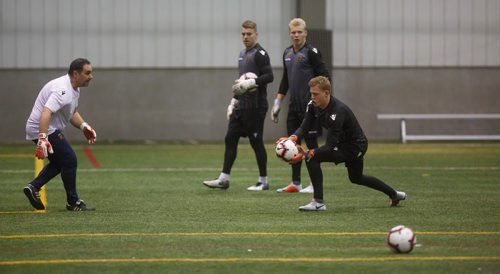 MIKE DEAL / WINNIPEG FREE PRESS
FC Valour goaltender Mathias Janssens catches the ball from goaltending coach Patrick Di Stefani (left) while Tyson Farago (centre) and Svyatik Artemenko (second from right) watch during practice at the Subway South Soccer Complex Tuesday morning.
190305 - Tuesday, March 05, 2019.