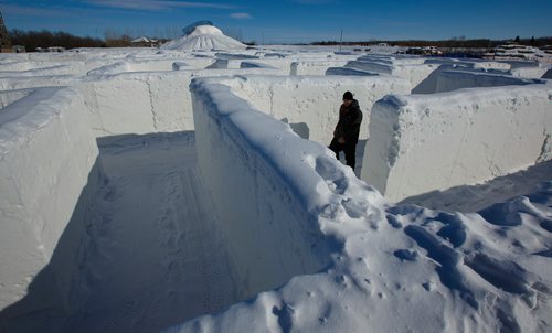 MIKE DEAL / WINNIPEG FREE PRESS
Jordan Dyck, an employee at A Maze In Corn, hauls some wood to one of the fire pits as he prepares for the coming weekend. Recently it was released that Guinness World Records declared the snow maze is the largest snow maze (at) 2,789.11 m² (30,021 ft² 110 in²) and was created by A Maze in Corn, Inc (Canada) in St. Adolphe, Manitoba, Canada, and measured on 10 February 2019."
190305 - Tuesday, March 05, 2019.